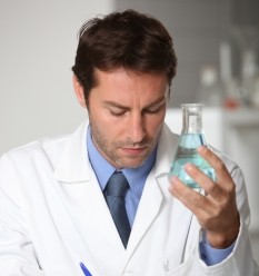 Photo of a scientist holding a beaker